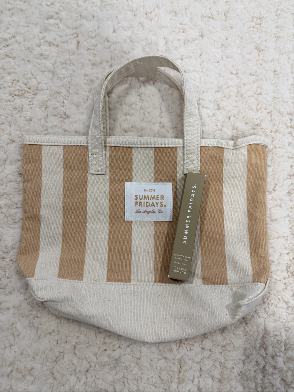 SUMMER FRIDAYS Beige & Cream Striped Canvas Mini Tote Bag and vanilla lip gloss